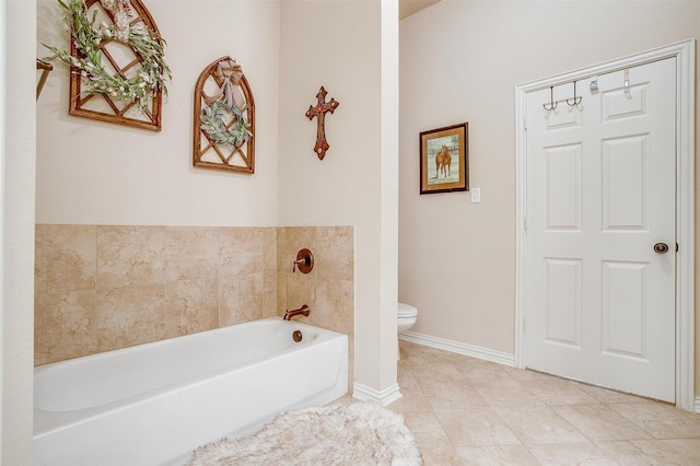 bathroom featuring a washtub, tile patterned flooring, and toilet