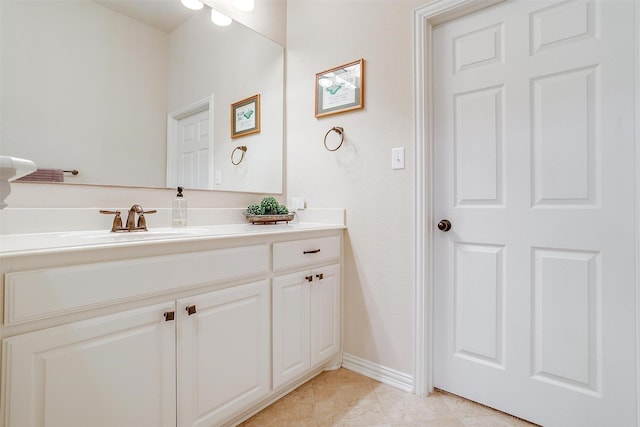 bathroom with vanity and baseboards