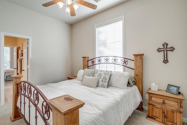 bedroom with ceiling fan and light colored carpet