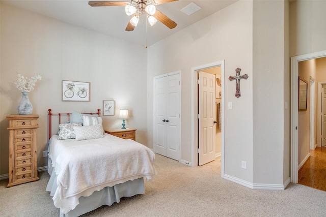 bedroom featuring a closet, light colored carpet, visible vents, ceiling fan, and baseboards