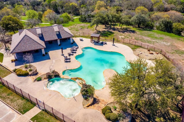 community pool with a gazebo, a patio, and fence