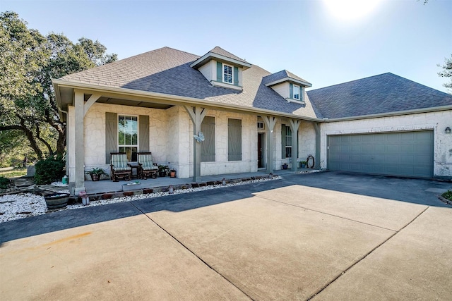 view of front facade featuring a porch and a garage