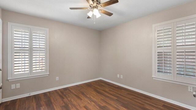 empty room with ceiling fan and dark wood-type flooring