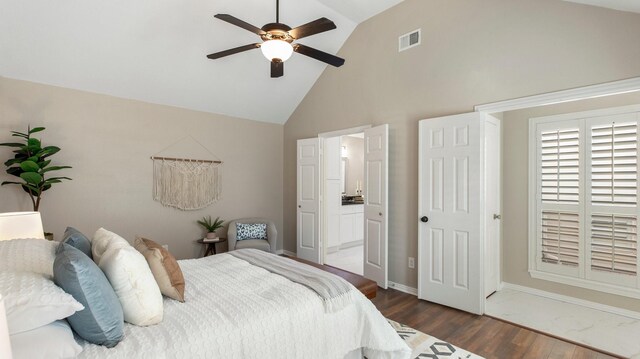 bedroom with high vaulted ceiling, ensuite bathroom, dark hardwood / wood-style floors, and ceiling fan