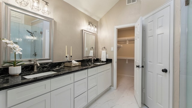 bathroom with a shower, vanity, and lofted ceiling