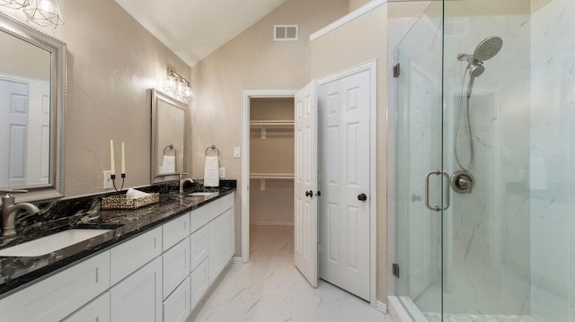 bathroom featuring vanity, an enclosed shower, and vaulted ceiling