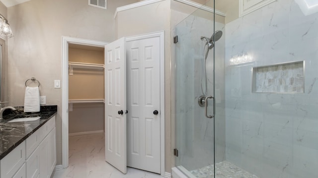 bathroom featuring vanity and an enclosed shower