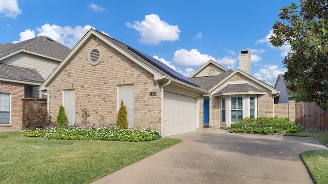 view of front of property with a garage and a front lawn