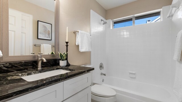 full bathroom featuring vanity, toilet, and tiled shower / bath combo