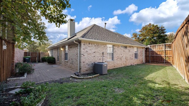 view of side of home featuring a lawn, a patio, and central AC