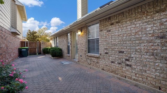 view of side of home featuring a patio area