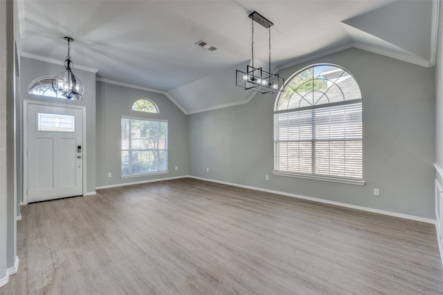 foyer with light wood-type flooring, vaulted ceiling, plenty of natural light, and a notable chandelier