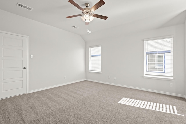 empty room with light carpet, ceiling fan, and lofted ceiling