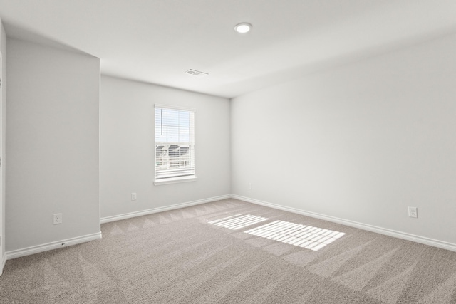 unfurnished room with light carpet