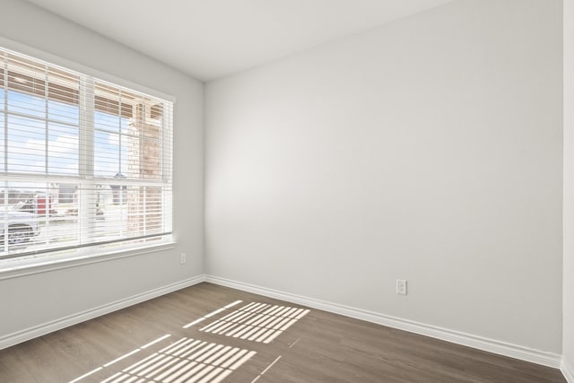 empty room with dark wood-type flooring