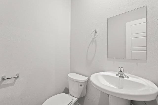 bathroom featuring toilet and sink