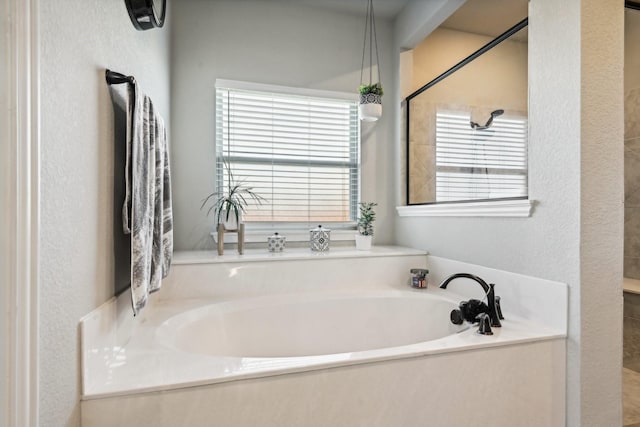 bathroom featuring shower with separate bathtub