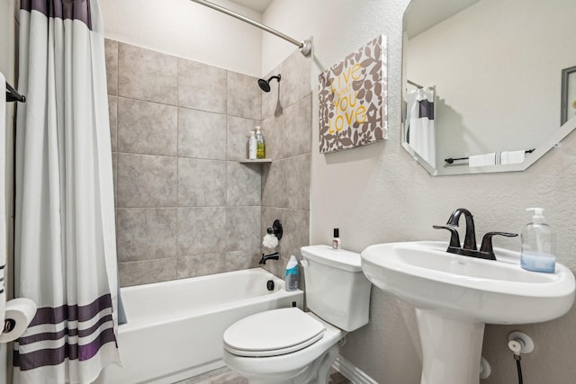 full bathroom with toilet, shower / bath combo with shower curtain, and sink