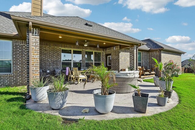 rear view of house with a lawn, ceiling fan, and a patio area