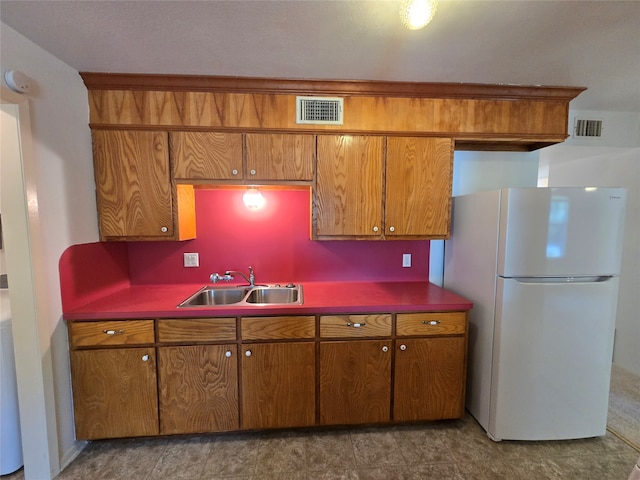 kitchen with white refrigerator and sink