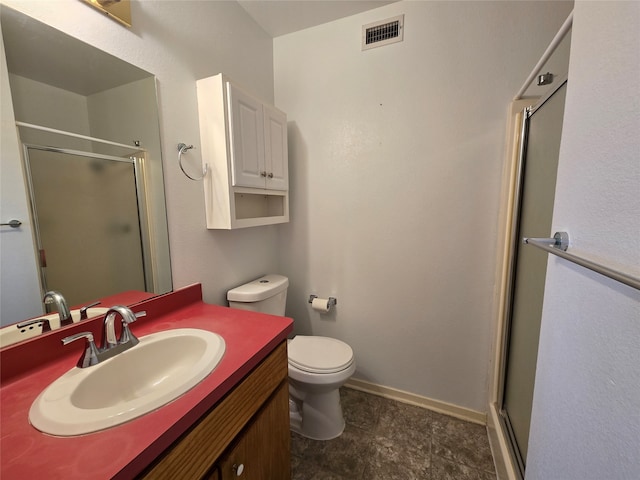 bathroom with walk in shower, vanity, and toilet