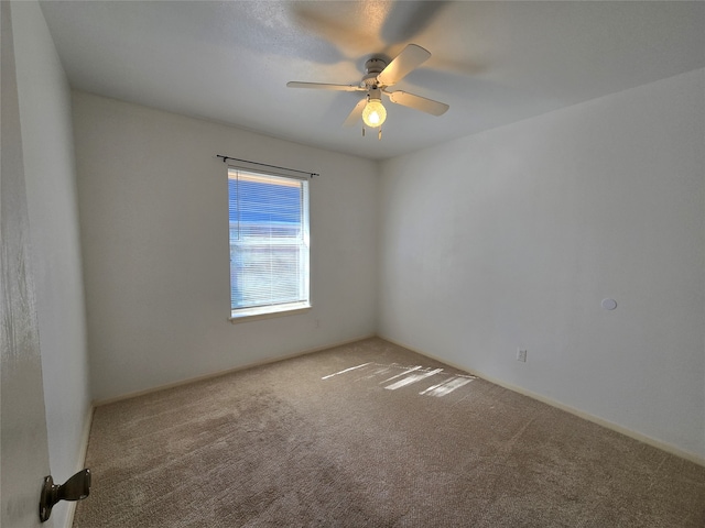 empty room with carpet floors and ceiling fan