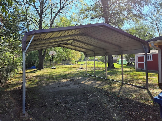 view of vehicle parking featuring a yard and a carport