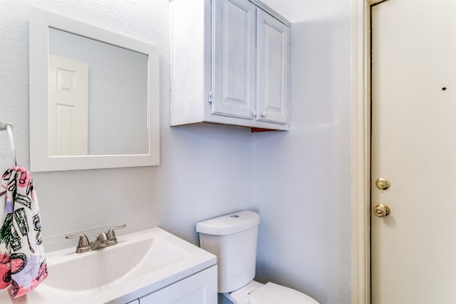 bathroom with toilet and vanity