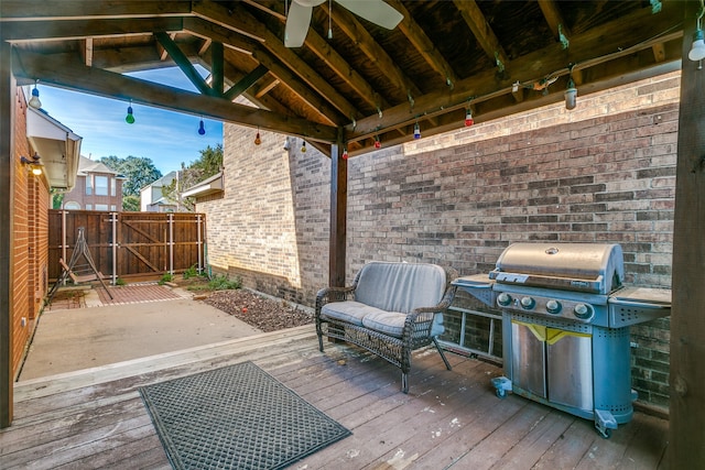 deck featuring area for grilling and ceiling fan