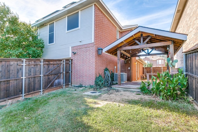 rear view of house featuring a lawn, a wooden deck, and cooling unit