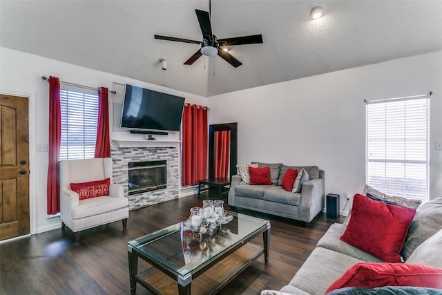 living room with ceiling fan, lofted ceiling, dark hardwood / wood-style floors, and plenty of natural light