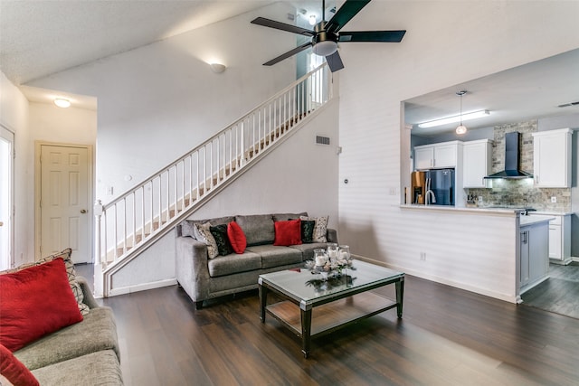 living room with a healthy amount of sunlight, high vaulted ceiling, and dark hardwood / wood-style floors