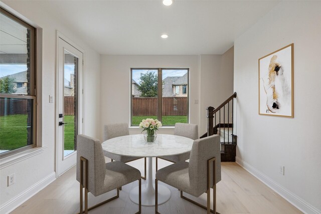 dining space featuring light wood-type flooring