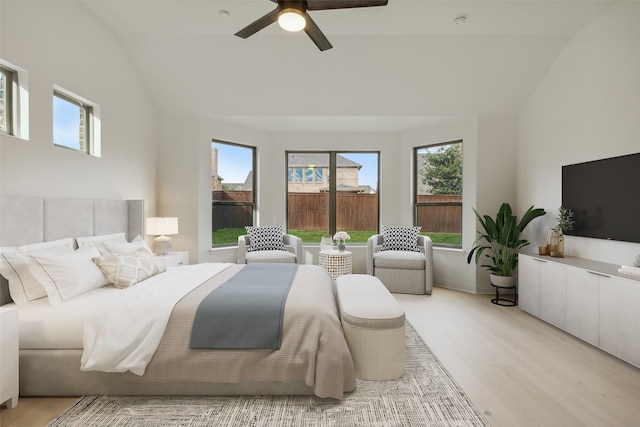 bedroom featuring high vaulted ceiling, light hardwood / wood-style floors, and ceiling fan