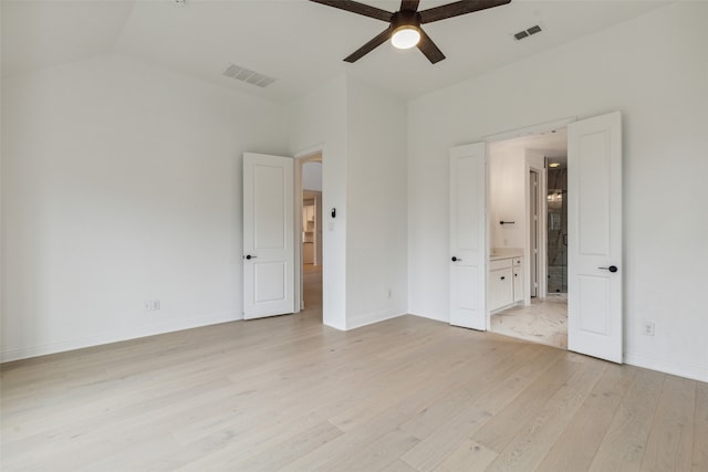 unfurnished bedroom featuring light wood-type flooring, lofted ceiling, ceiling fan, and connected bathroom