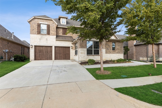 view of front of property with a garage and a front lawn