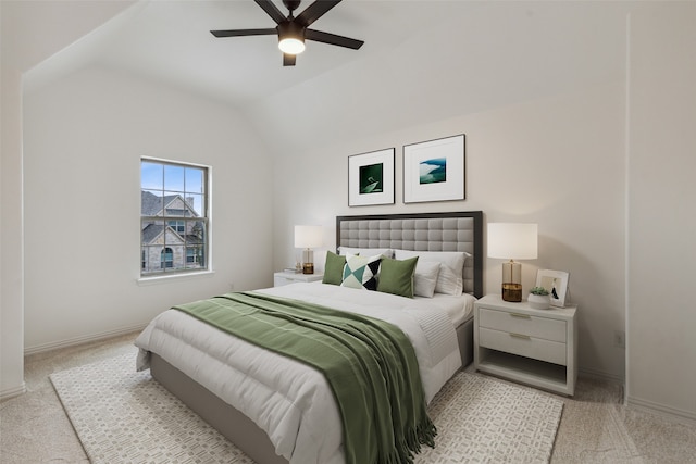 bedroom with ceiling fan, vaulted ceiling, and light colored carpet