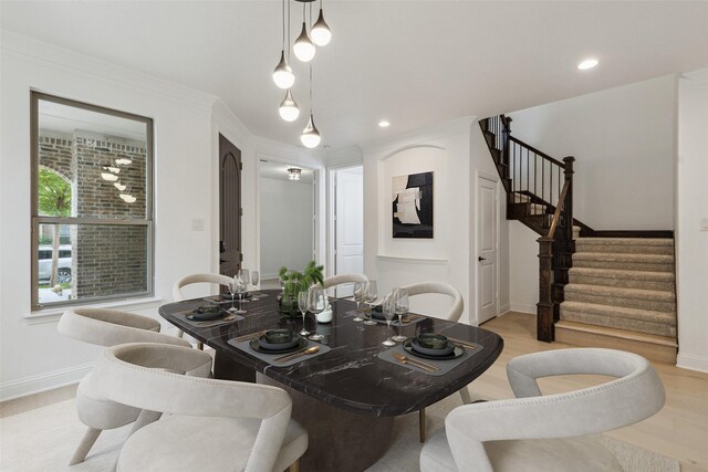 dining room featuring light hardwood / wood-style floors and ornamental molding