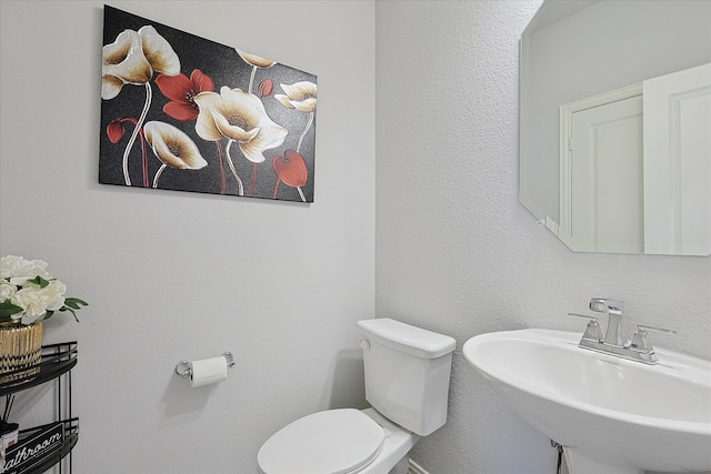 bathroom featuring toilet and sink