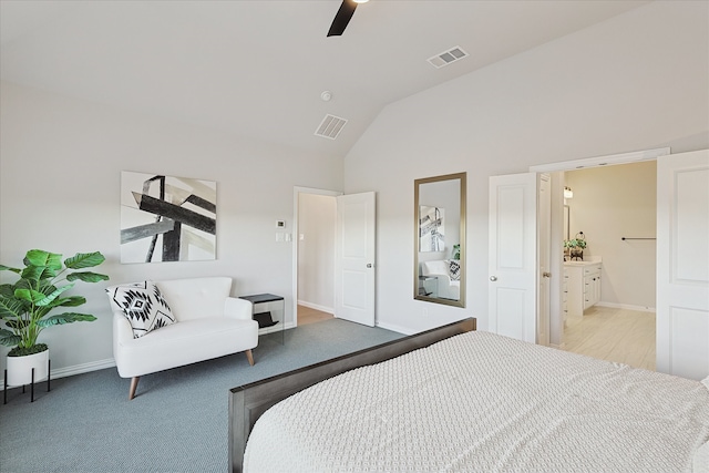 bedroom with light colored carpet, ceiling fan, lofted ceiling, and ensuite bathroom