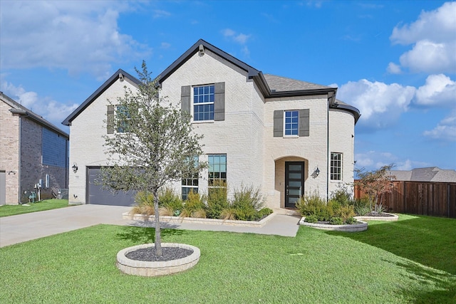 view of front of home with a garage and a front lawn