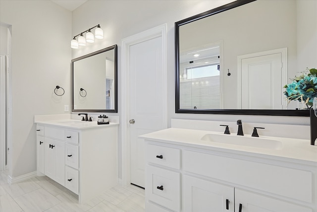 bathroom with vanity and a shower with door