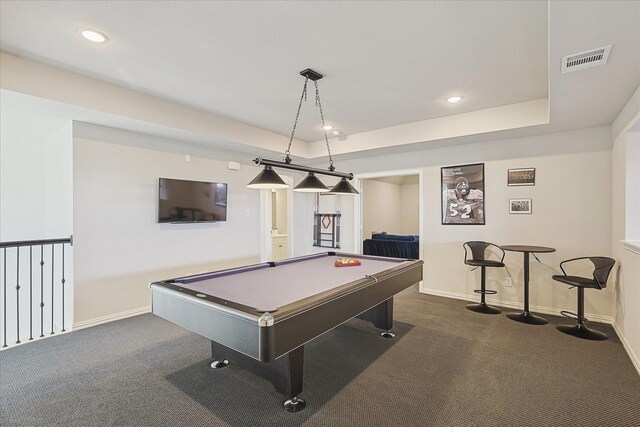 game room featuring dark colored carpet, a raised ceiling, and billiards