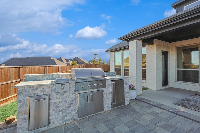 view of patio / terrace featuring a grill and exterior kitchen