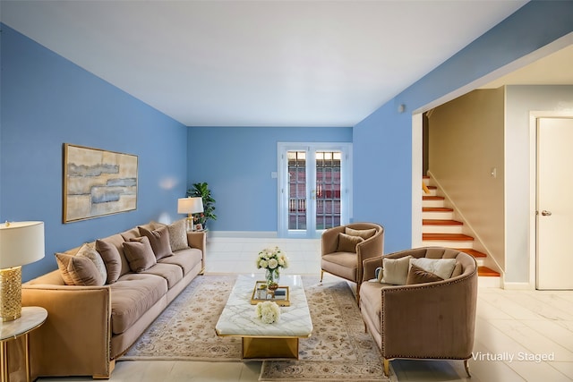 living room featuring stairway and baseboards