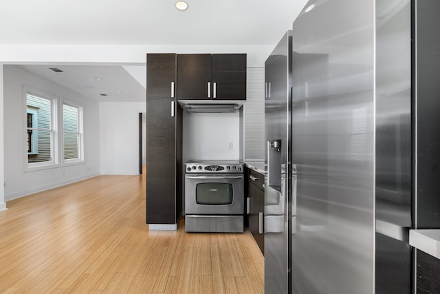 kitchen with light hardwood / wood-style floors and appliances with stainless steel finishes