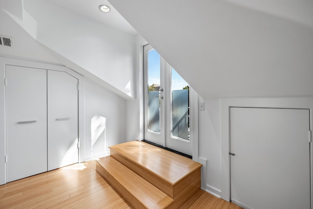 bonus room with light hardwood / wood-style flooring