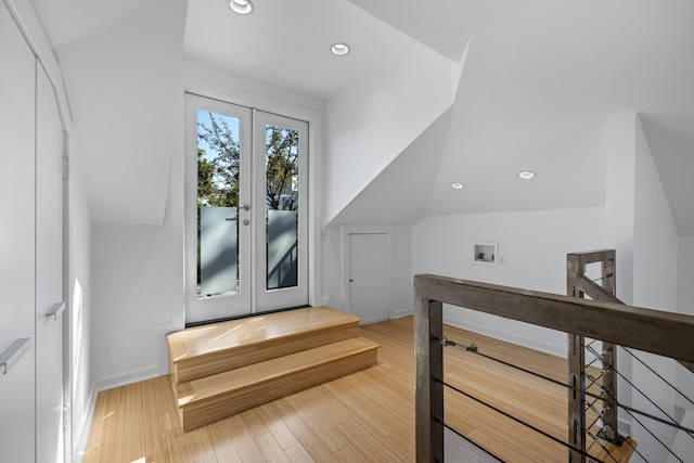 bonus room featuring french doors, hardwood / wood-style floors, and lofted ceiling