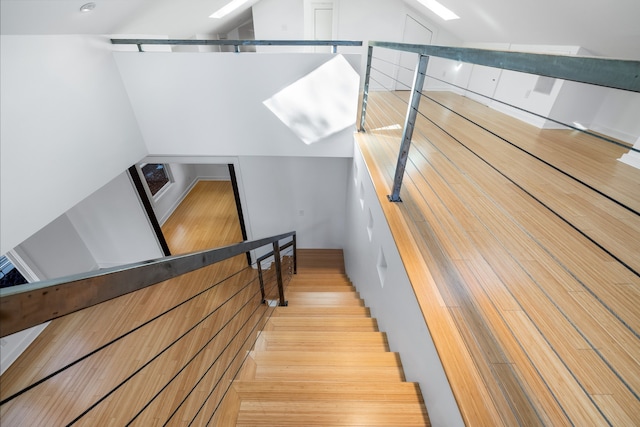 stairway with hardwood / wood-style flooring