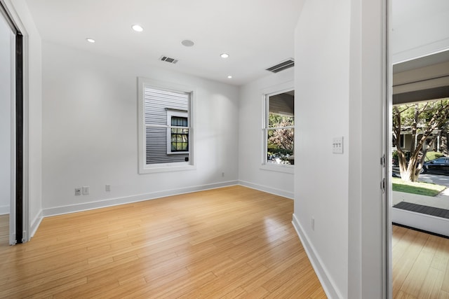 spare room featuring light wood-type flooring